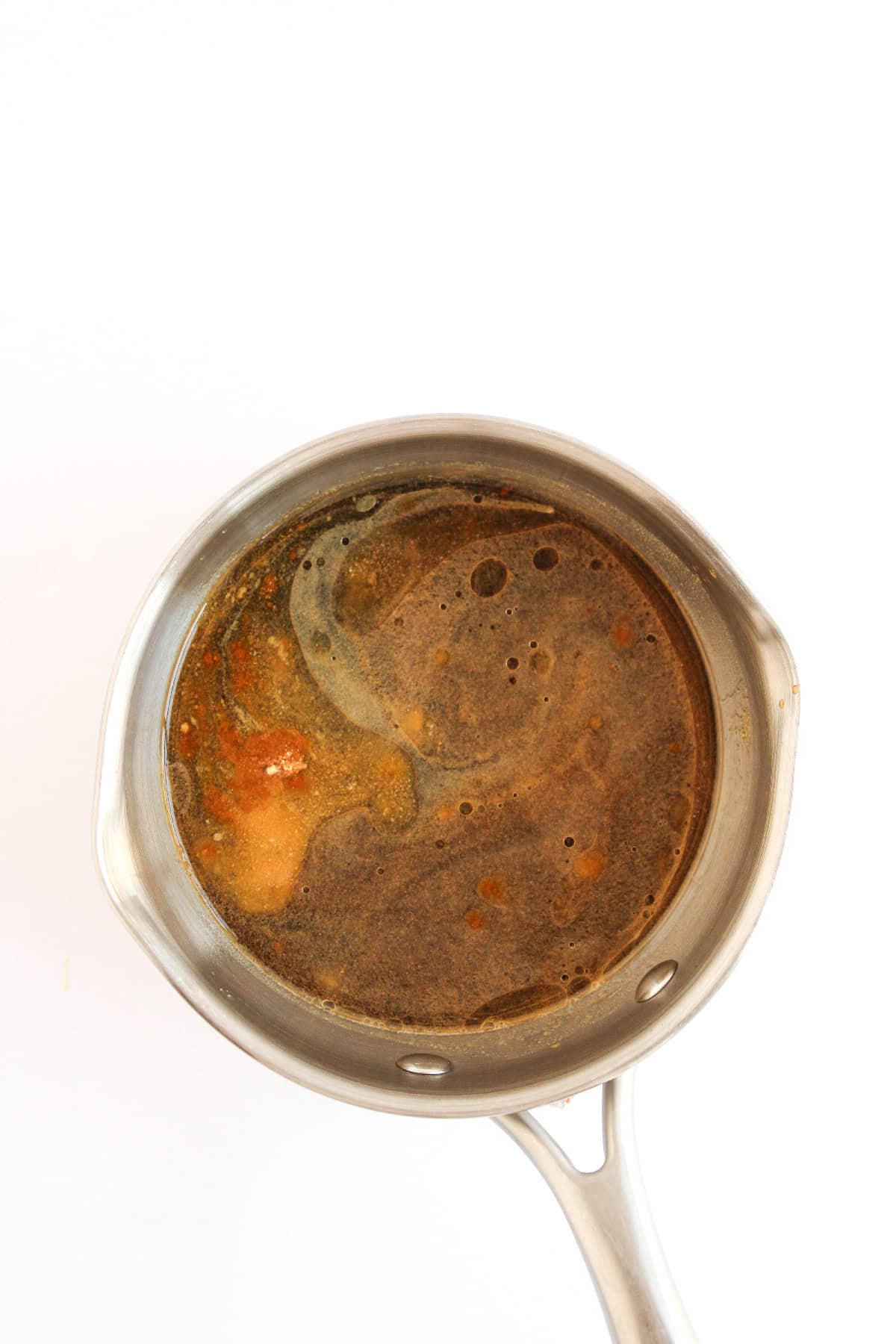 Teriyaki sauce ingredients simmering in a saucepan.