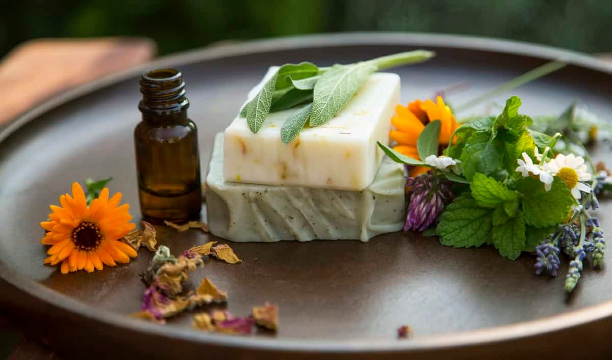 Handcrafted vegan soap with herbs and flowers, representing natural and cruelty-free skincare.