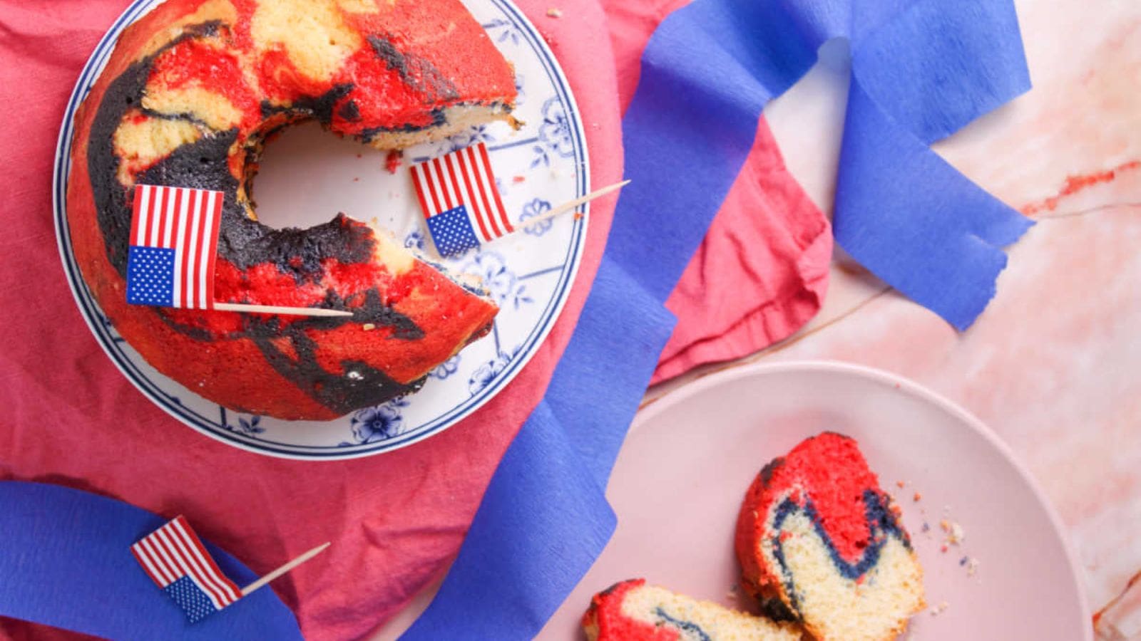 Bundt cake decorated with red, white, and blue frosting and festive toppings.
