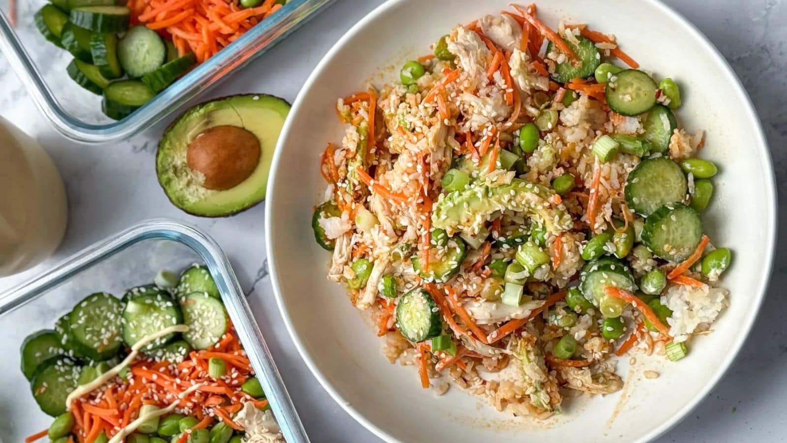 Chicken rice bowls topped with vegetables and Asian-inspired sauce.