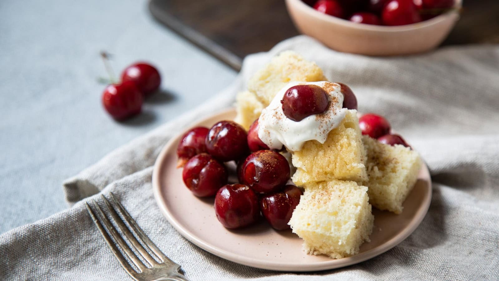 Grilled pound cake topped with cherries and sweet sauce.