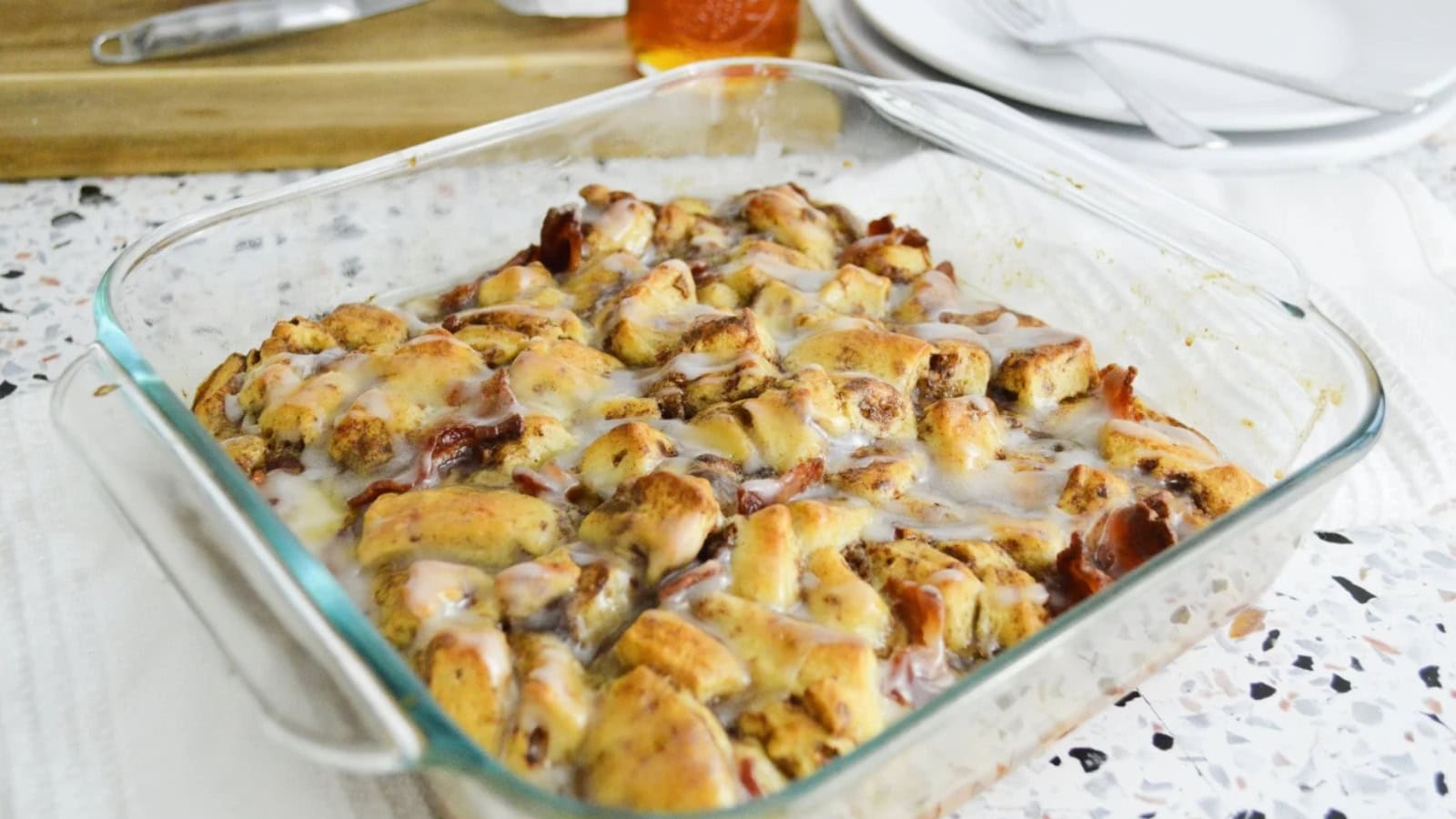 French toast casserole baked with cinnamon rolls and crispy bacon pieces.