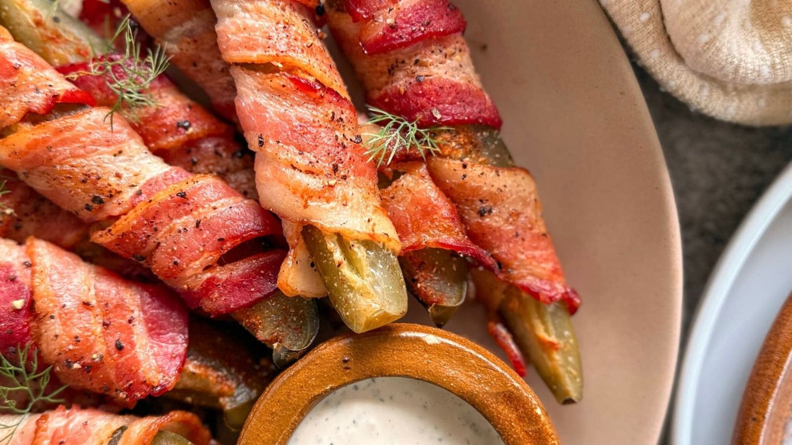 Dill pickles wrapped in crispy bacon and baked until golden and smoky.