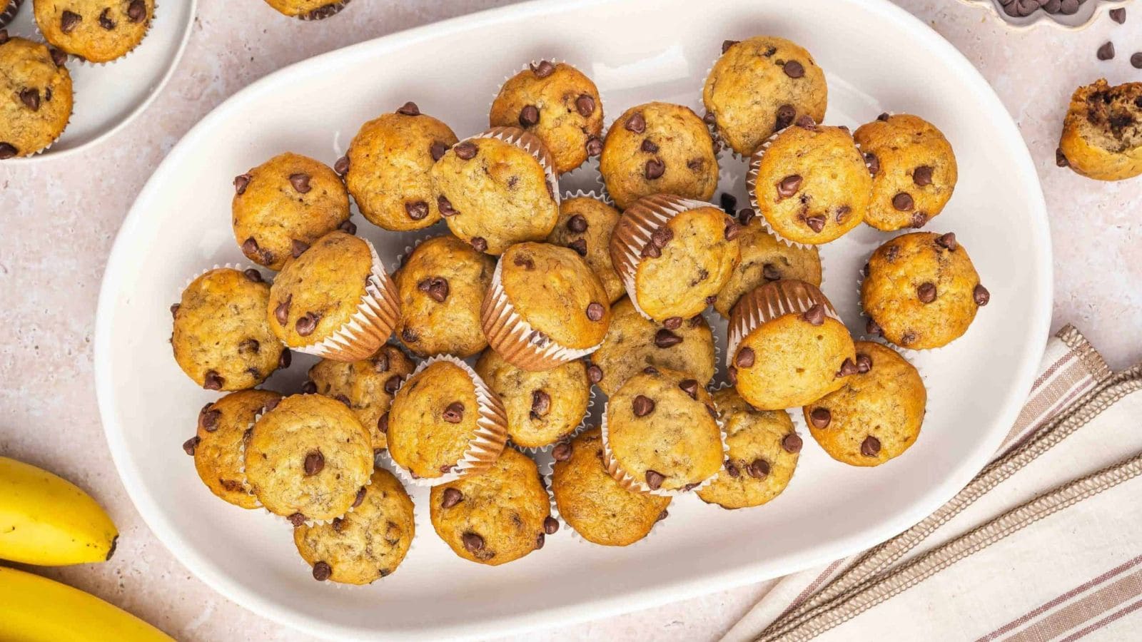 Banana mini muffins filled with chocolate chips and baked fluffy.
