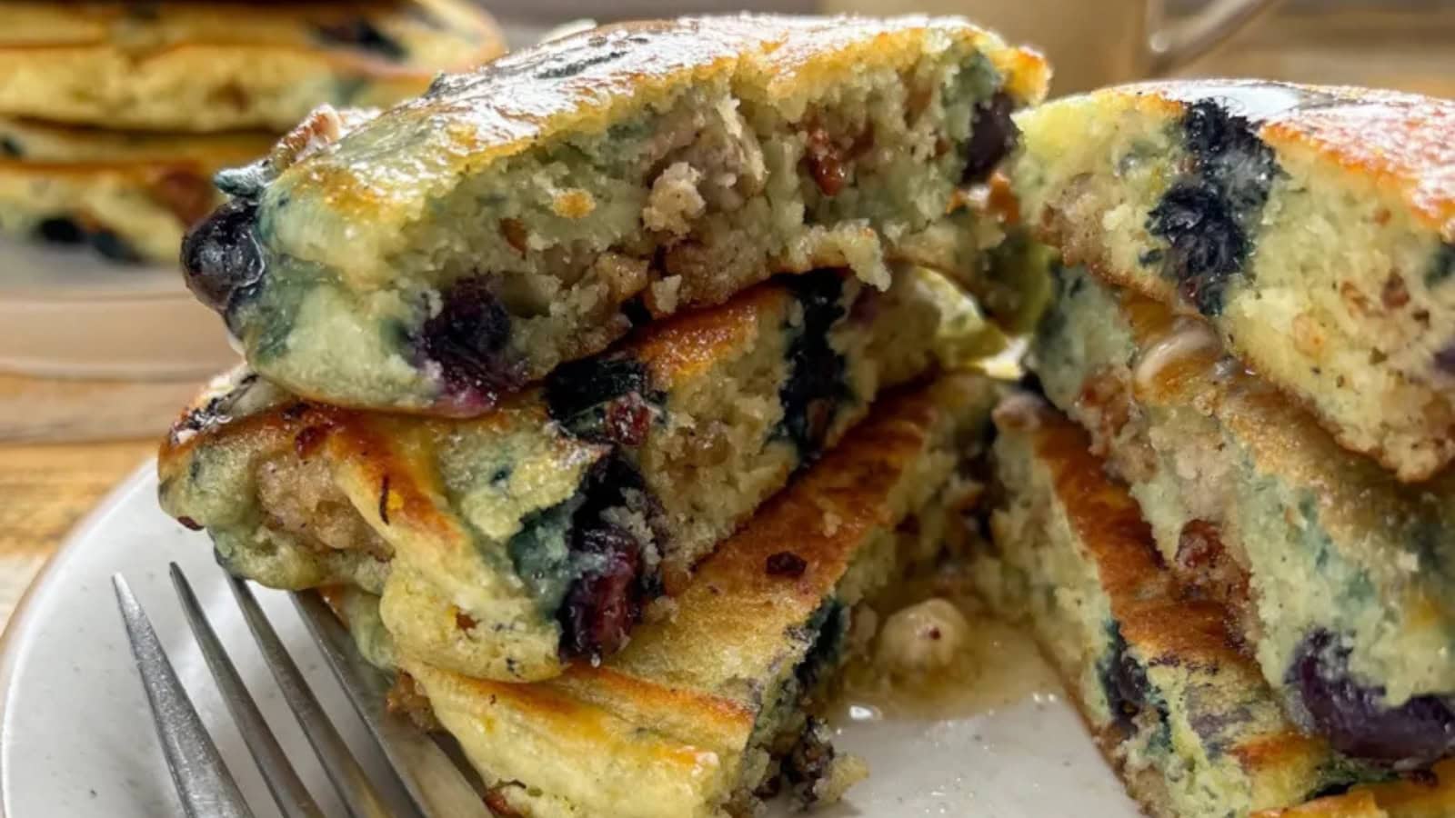 Pancakes stuffed with sausage and blueberries with golden edges.
