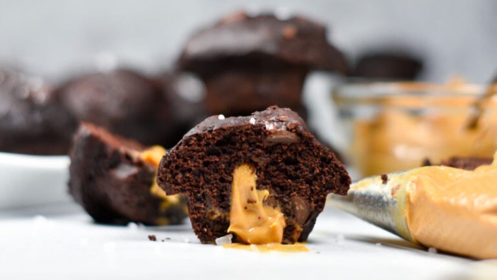 Mini muffins filled with peanut butter and chocolate chips in a soft crumb.