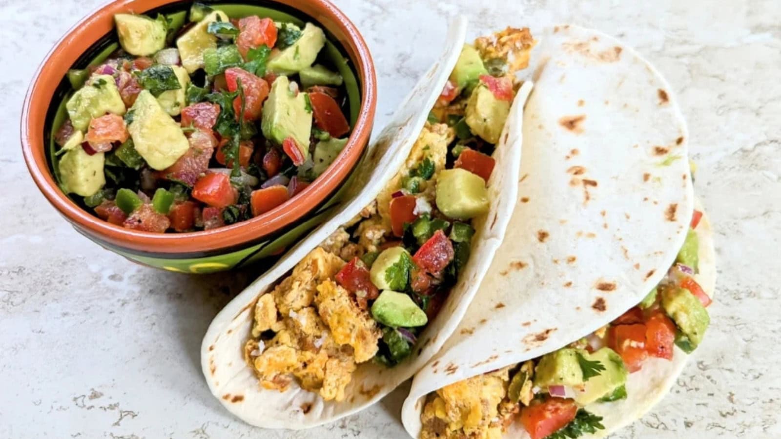 Breakfast tacos filled with chorizo, eggs, and fresh toppings.