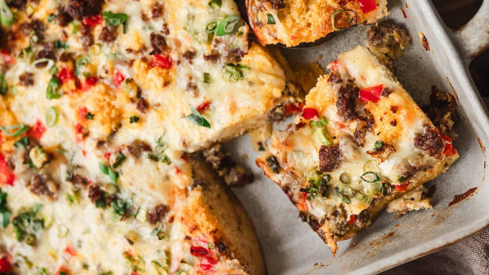 Cornbread breakfast casserole layered with sausage, cheese, and southwestern flavors.