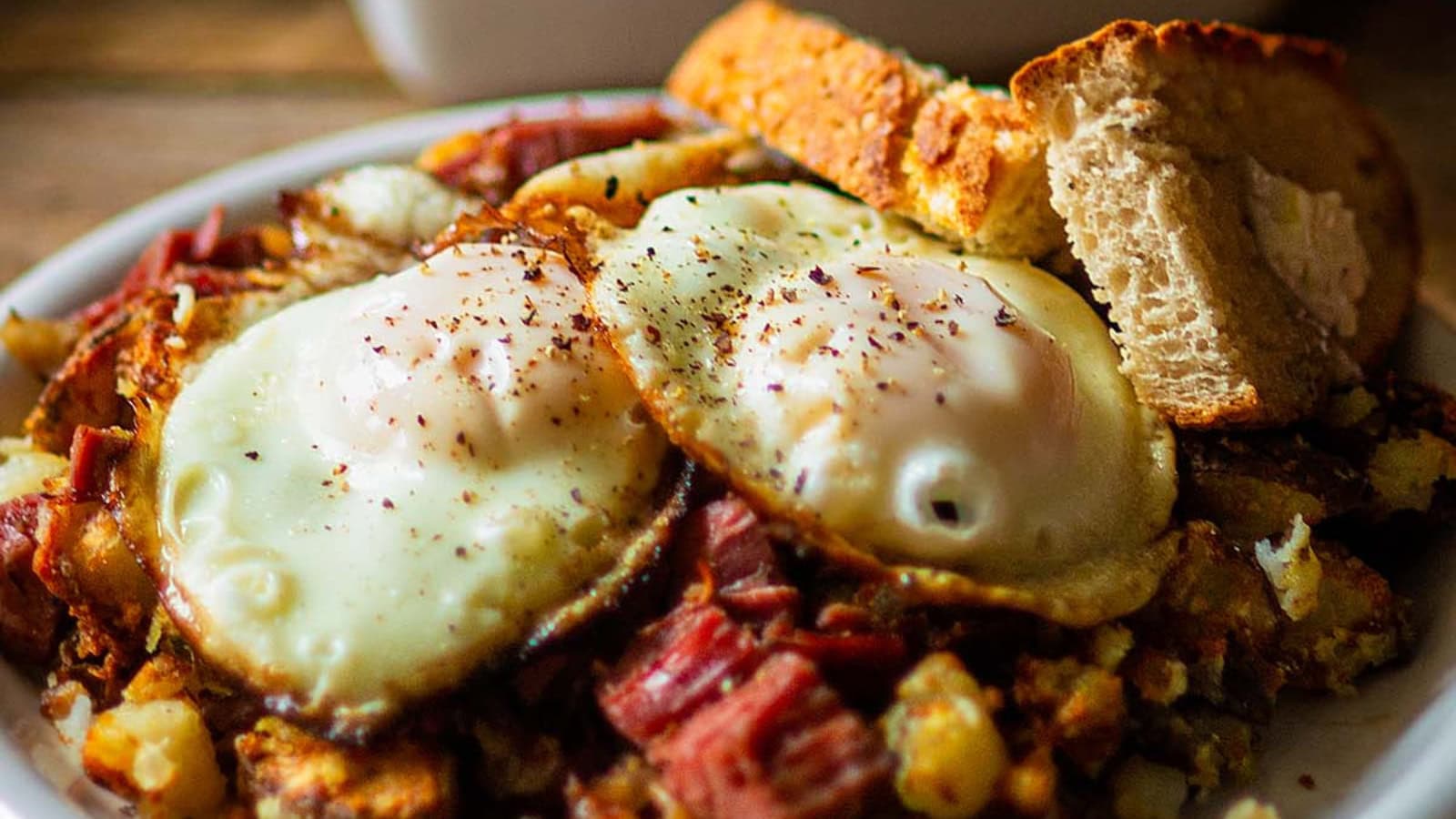Corned beef hash cooked with crispy potatoes and savory beef.