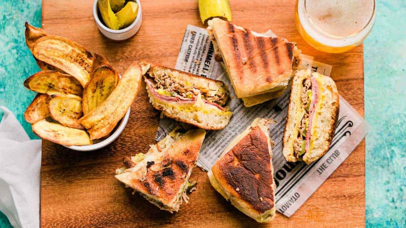 Cuban sandwich layered with pork, ham, cheese, and pickles in pressed bread.