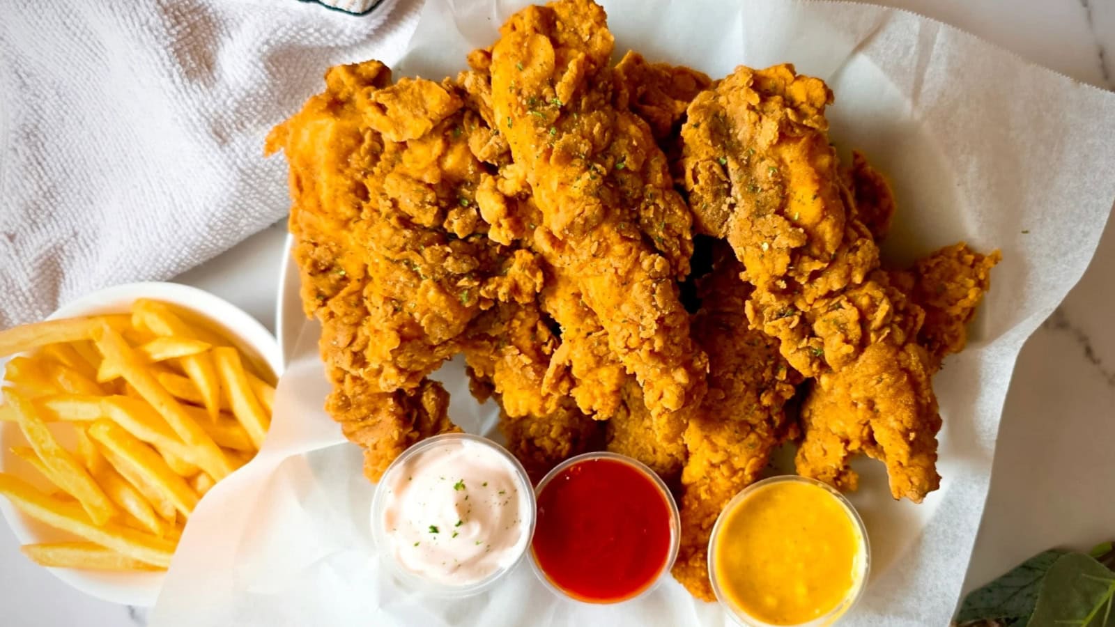 Fried chicken tenders coated in crispy buttermilk breading with golden crust.