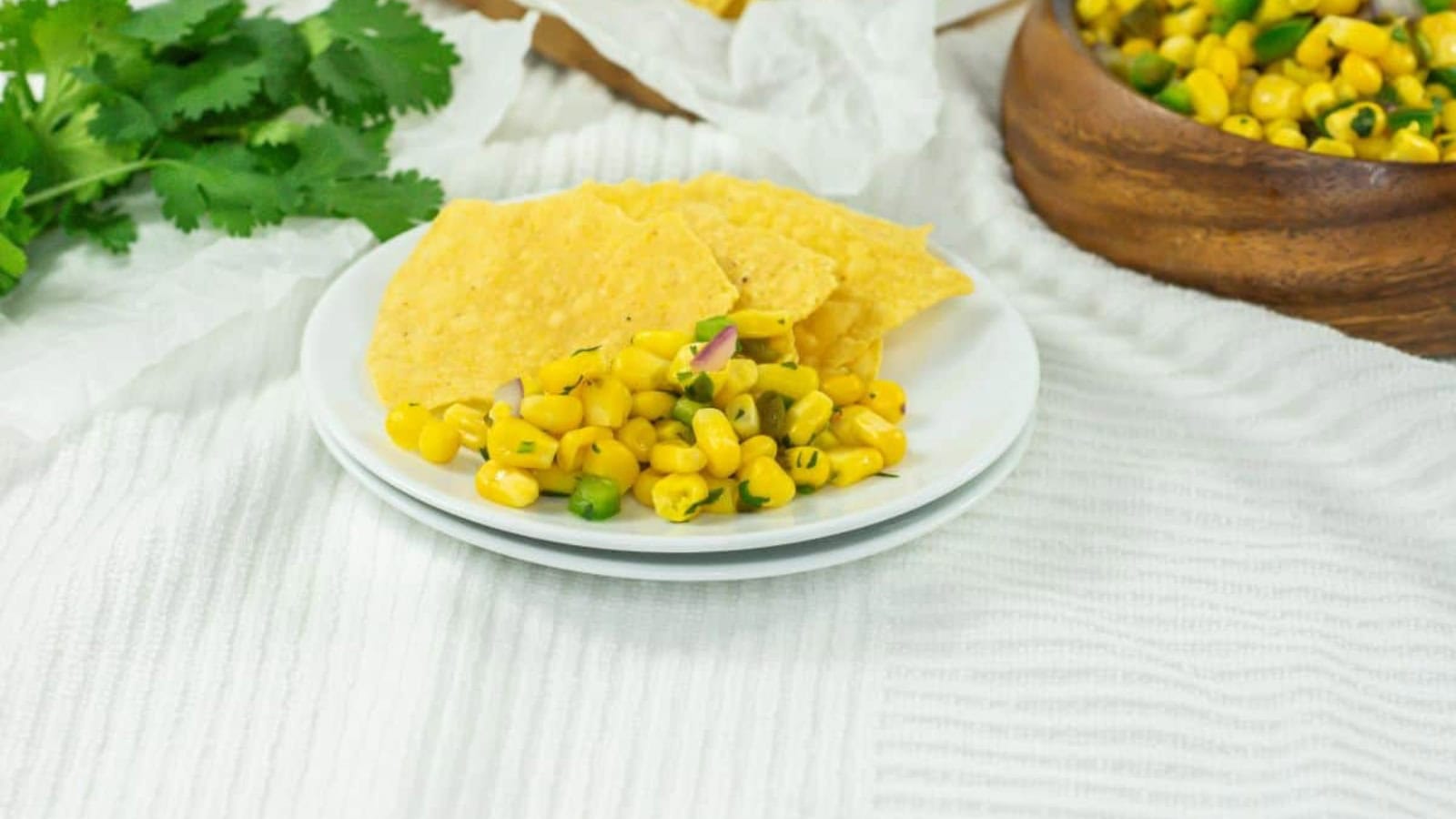 Corn salsa mixed with corn, peppers, and fresh herbs.