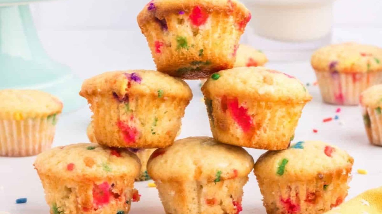 Mini funfetti muffins baked colorful with rainbow sprinkles throughout.