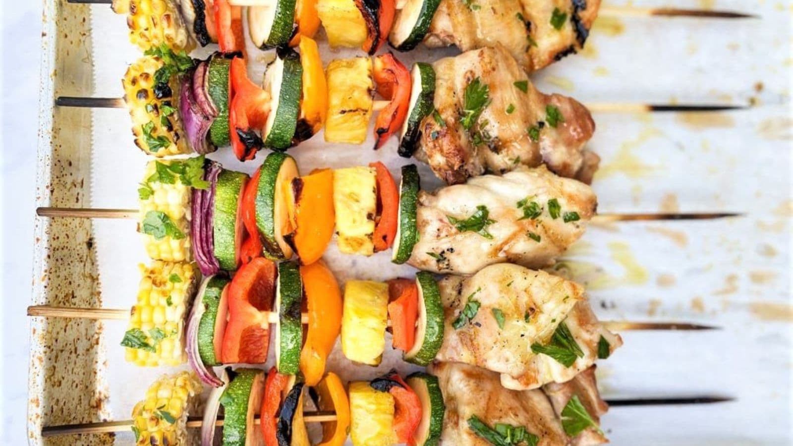 Chicken kabobs grilled with colorful vegetables and lightly charred edges.