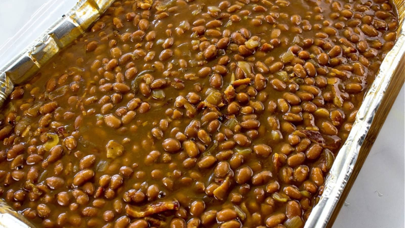 Baked beans cooked with crispy bacon in a rich savory sauce.