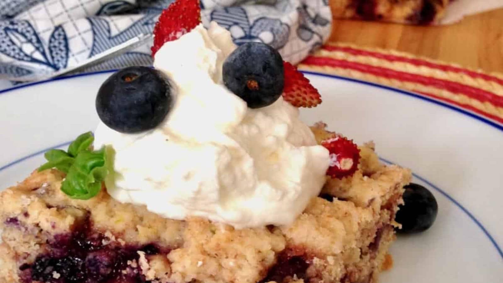 Shortcake topped with fresh berries and whipped cream.