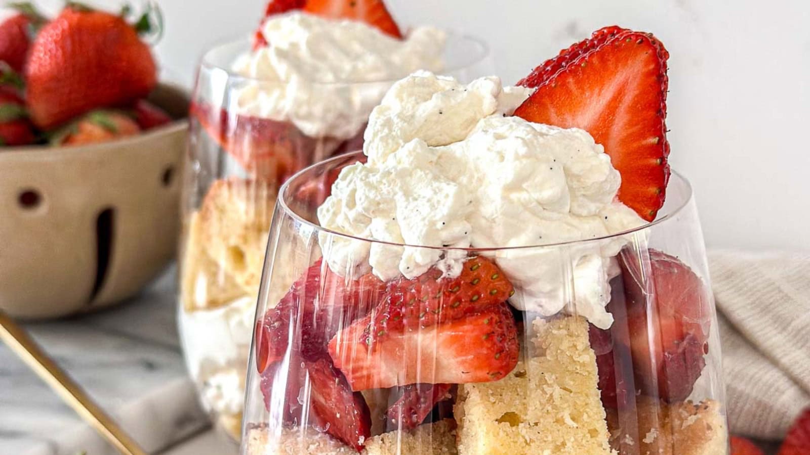 Strawberry parfaits layered with cake, berries, and cream.