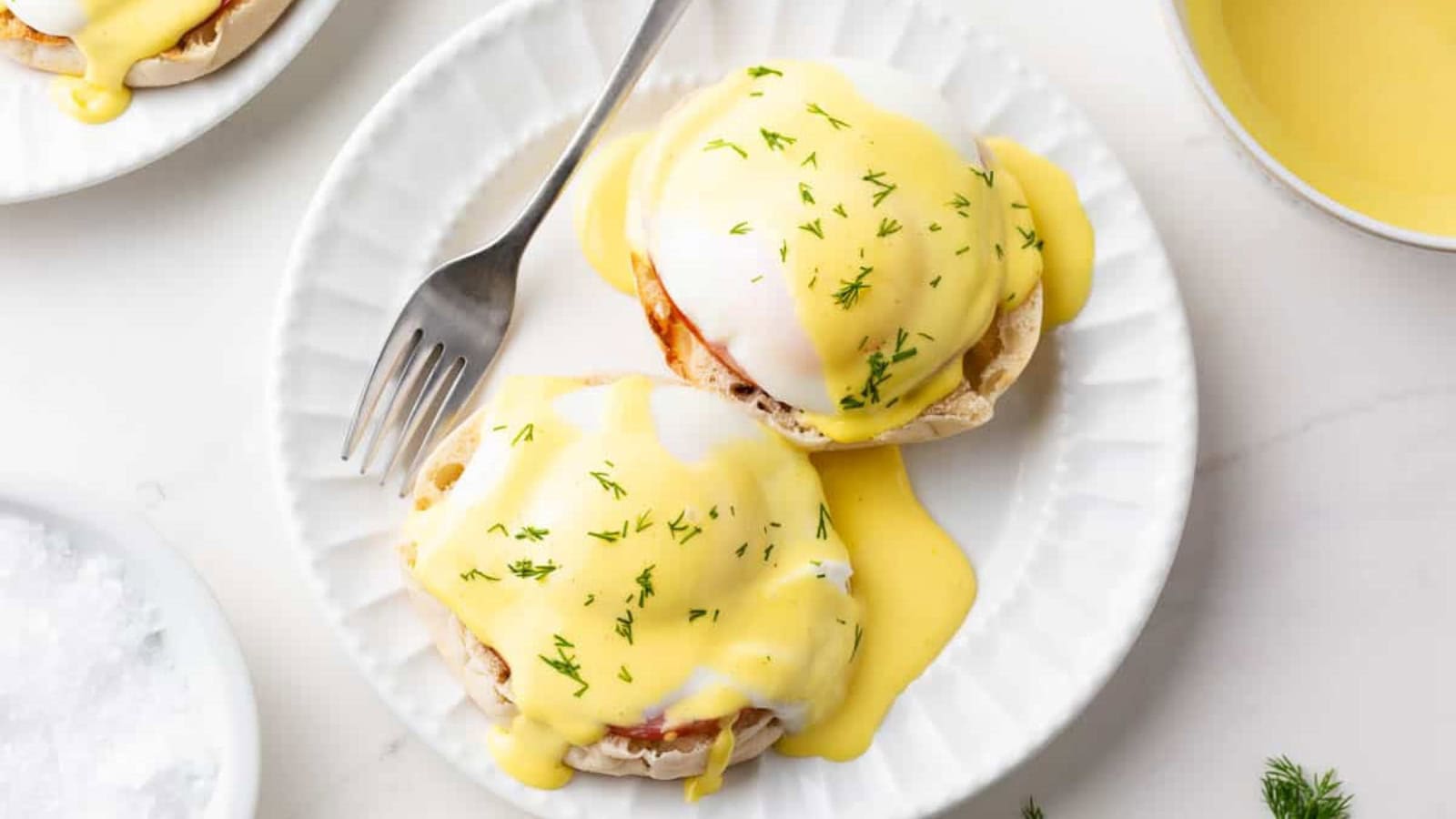 Eggs Benedict casserole baked with eggs, bread, and creamy sauce.