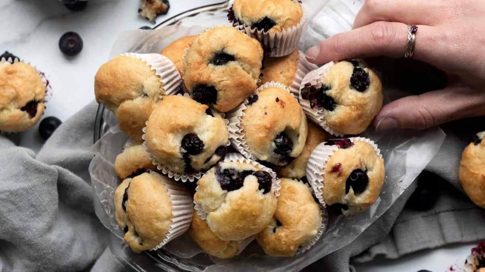 Gluten-free blueberry muffins baked soft with fresh blueberries throughout.