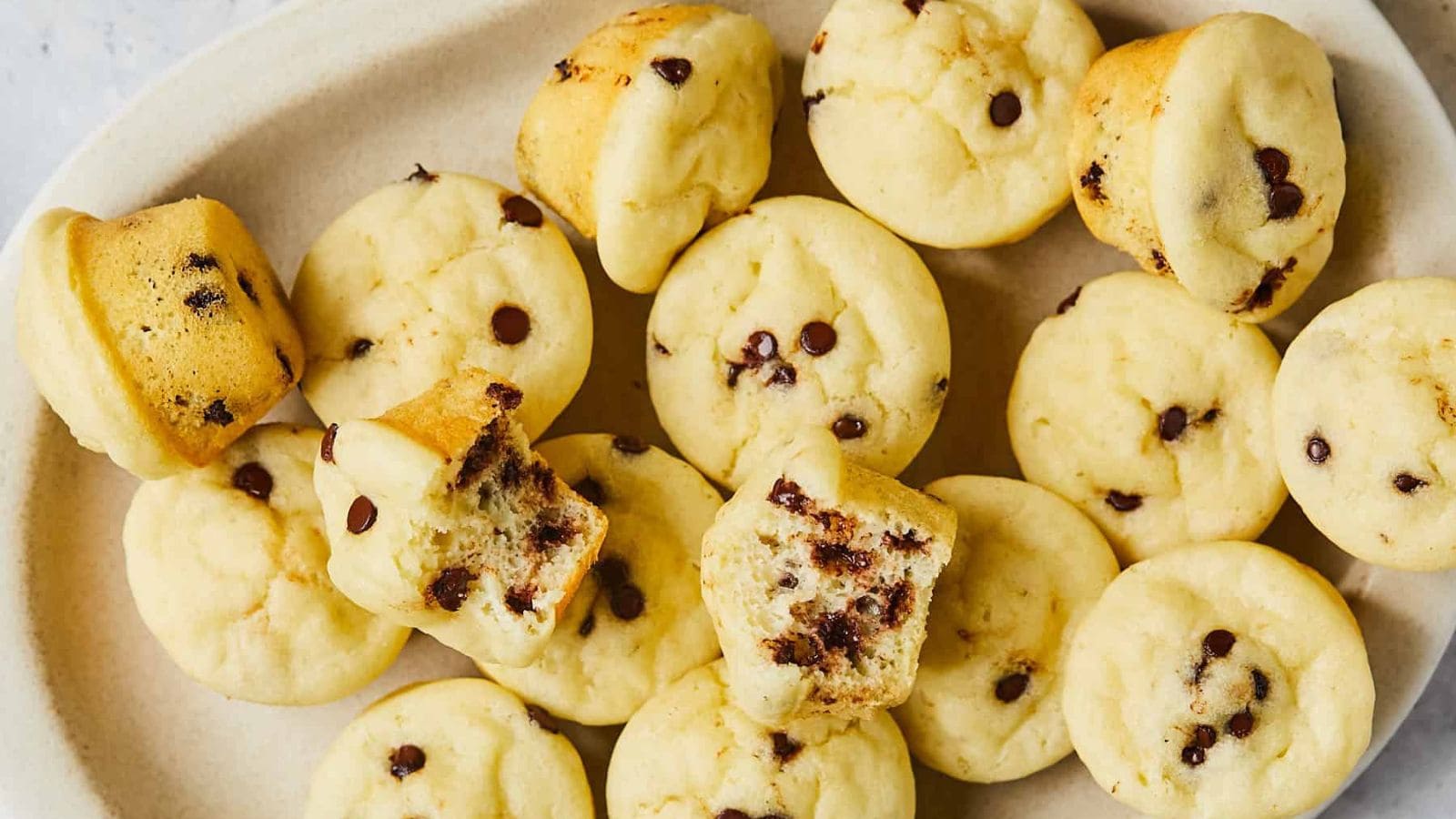 Gluten-free mini muffins baked soft with golden muffin tops.