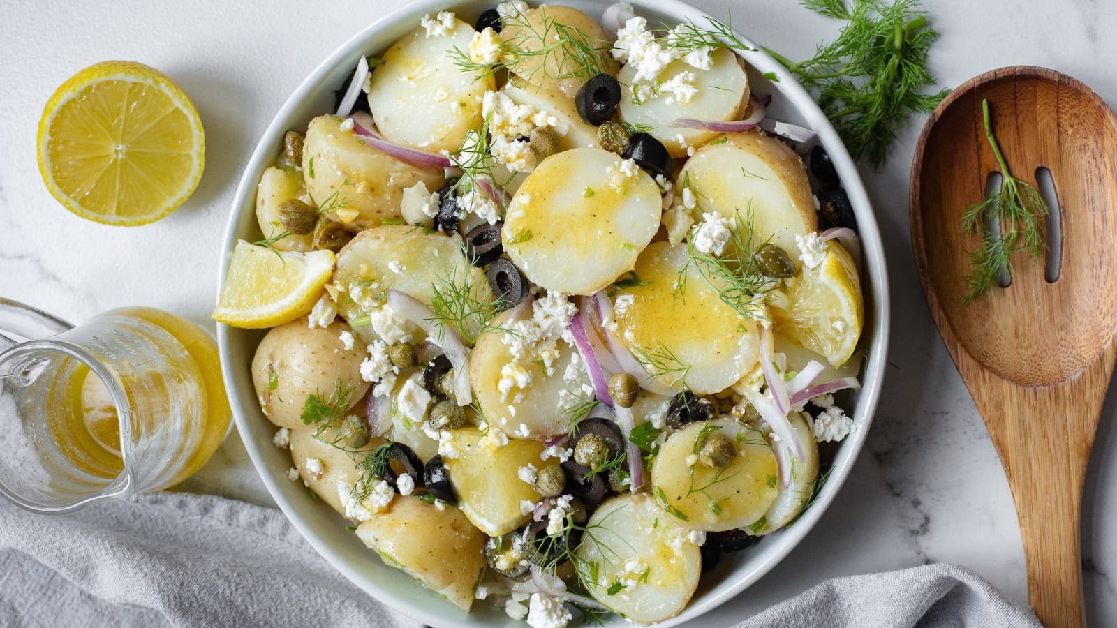 Potato salad tossed with herbs, vegetables, and Greek-inspired flavors.