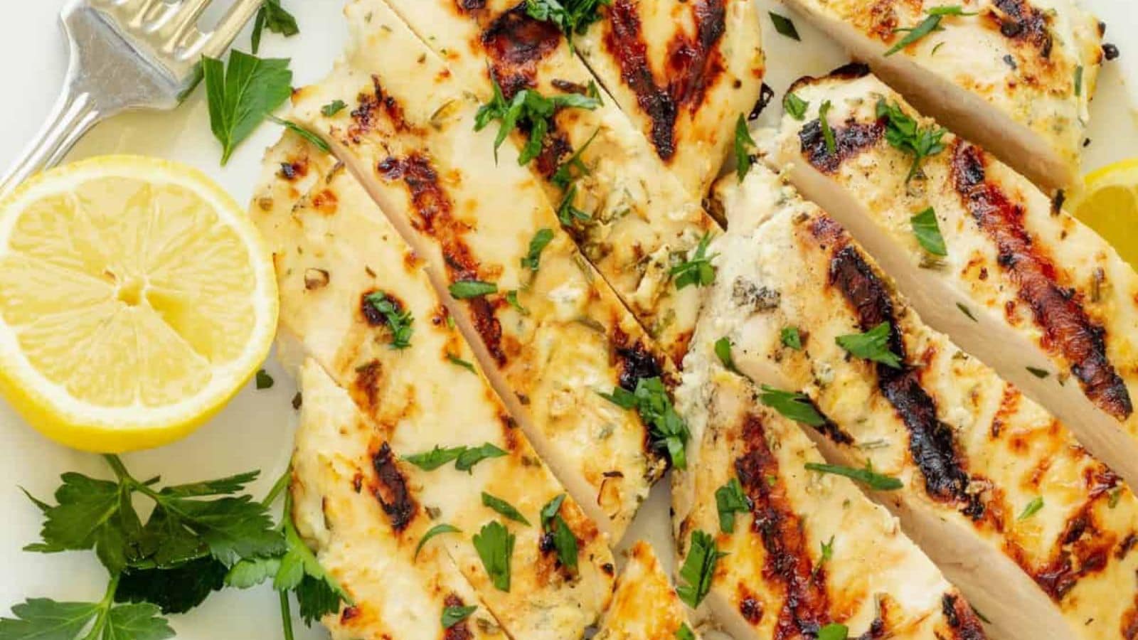 Yogurt marinated chicken grilled juicy with lightly charred seasoning.