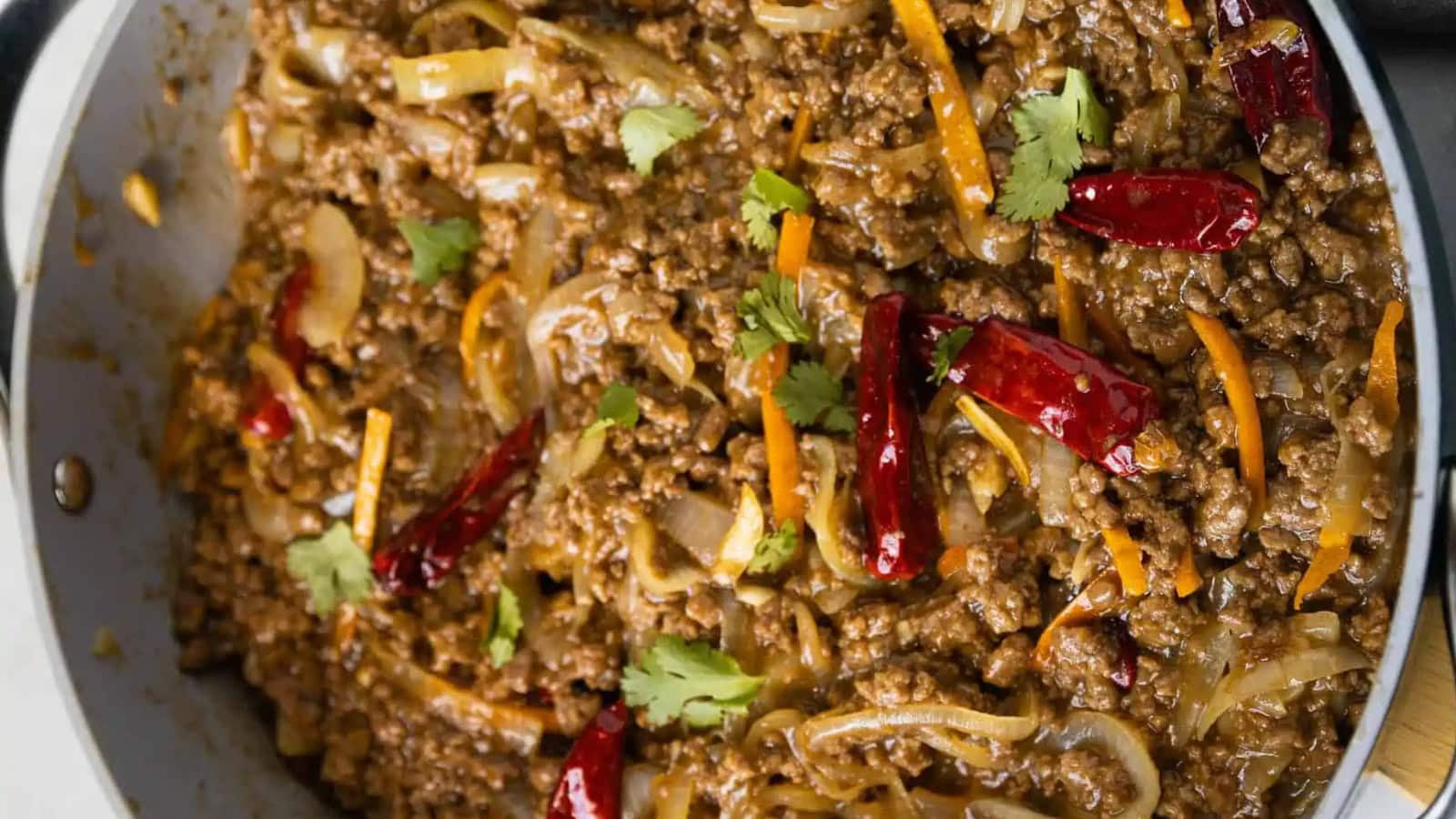 Ground beef stir fry mixed with vegetables and savory sauce over rice.