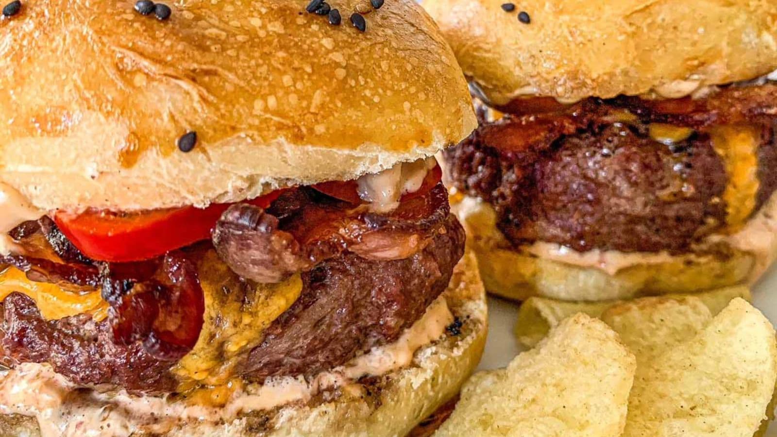 Smoked burgers topped with melted cheese and served on soft buns.