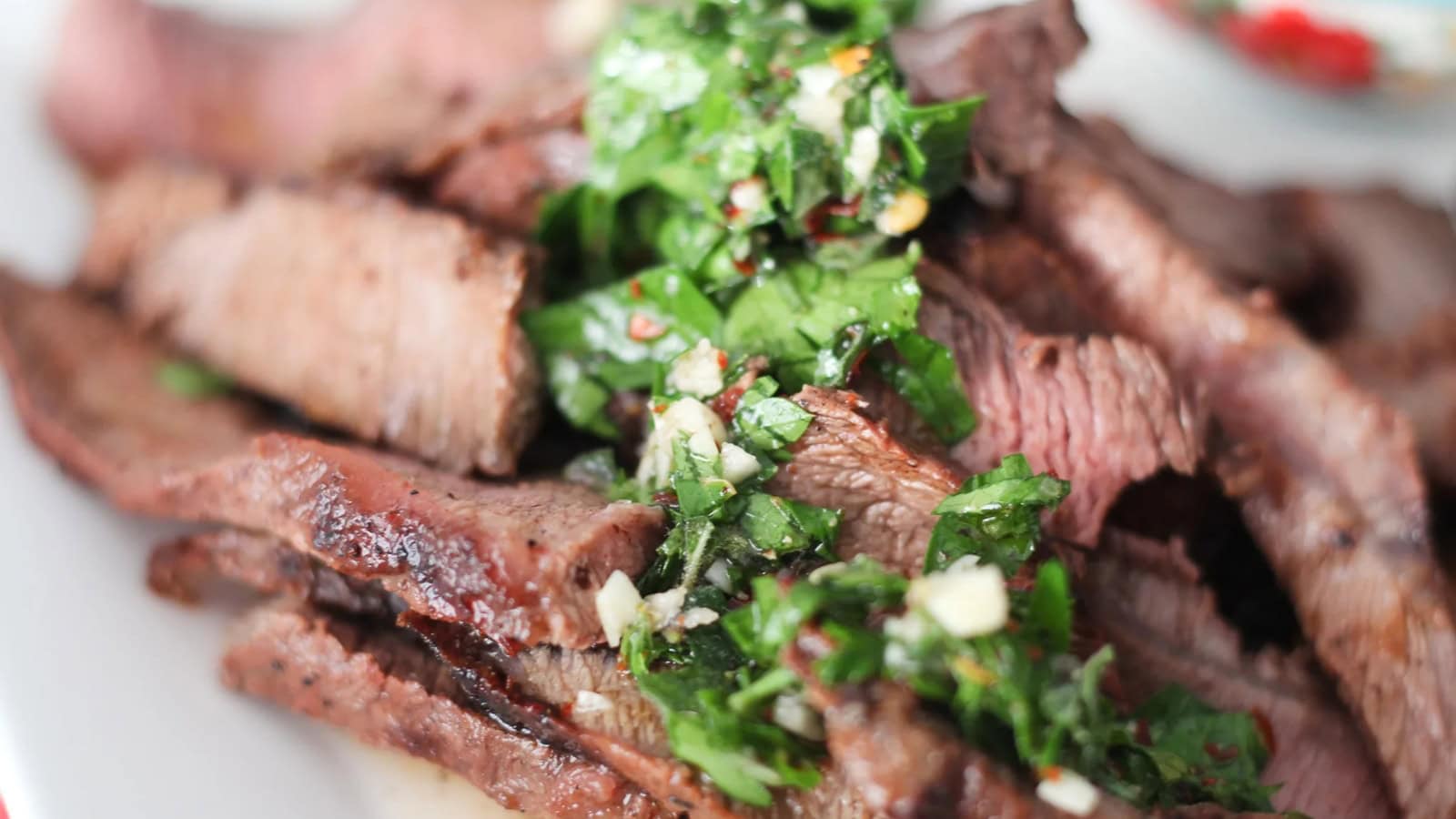 Grilled skirt steak sliced tender with charred edges and marinade glaze.