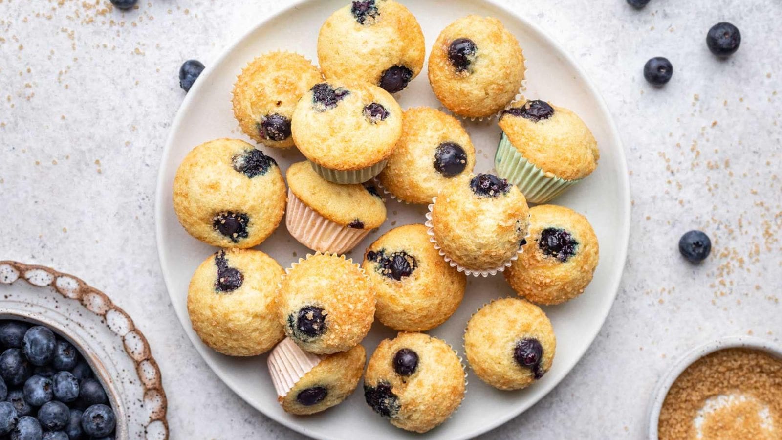Mini blueberry muffins baked tender with juicy berries throughout.