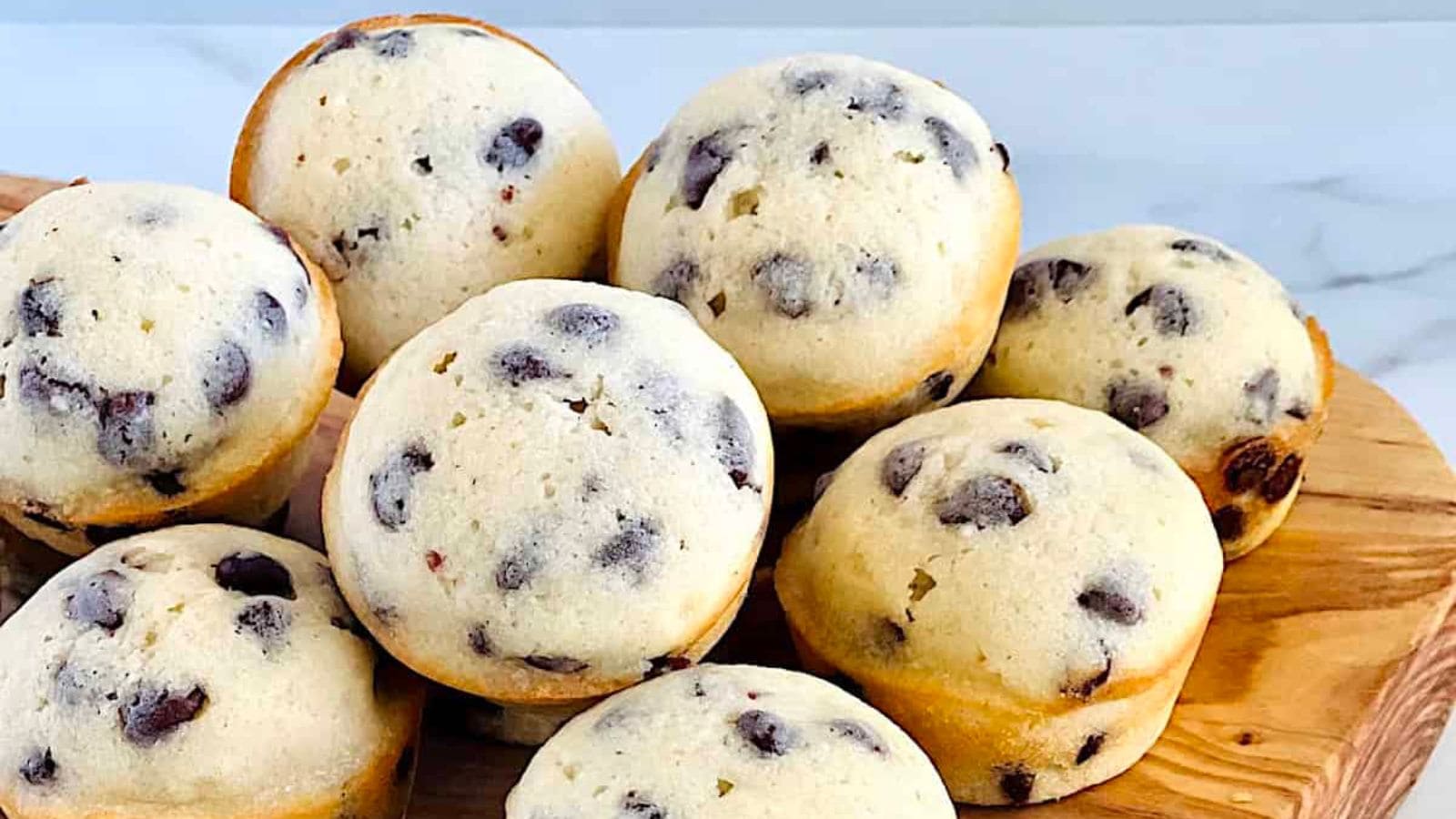 Mini chocolate chip muffins baked fluffy with melted chocolate chips.