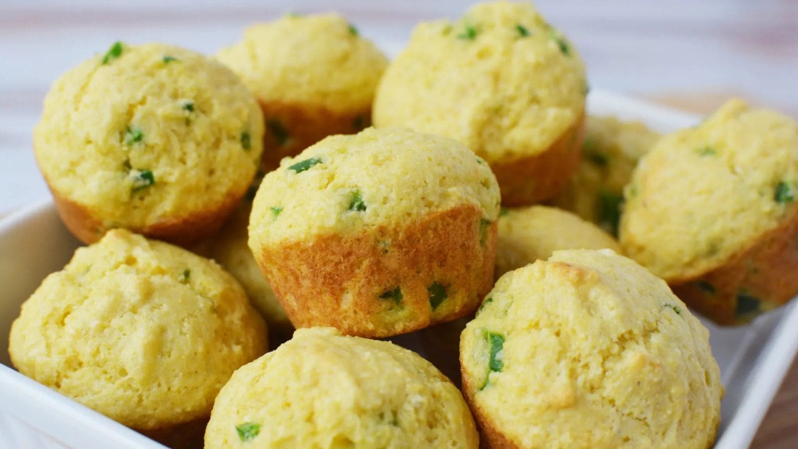 Cornbread muffins baked golden with a moist and fluffy texture.