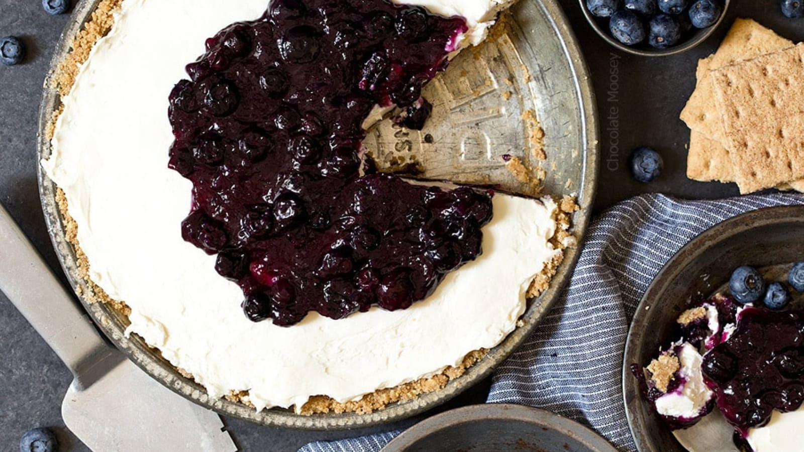 Blueberry cheesecake pie with creamy filling and berry topping.