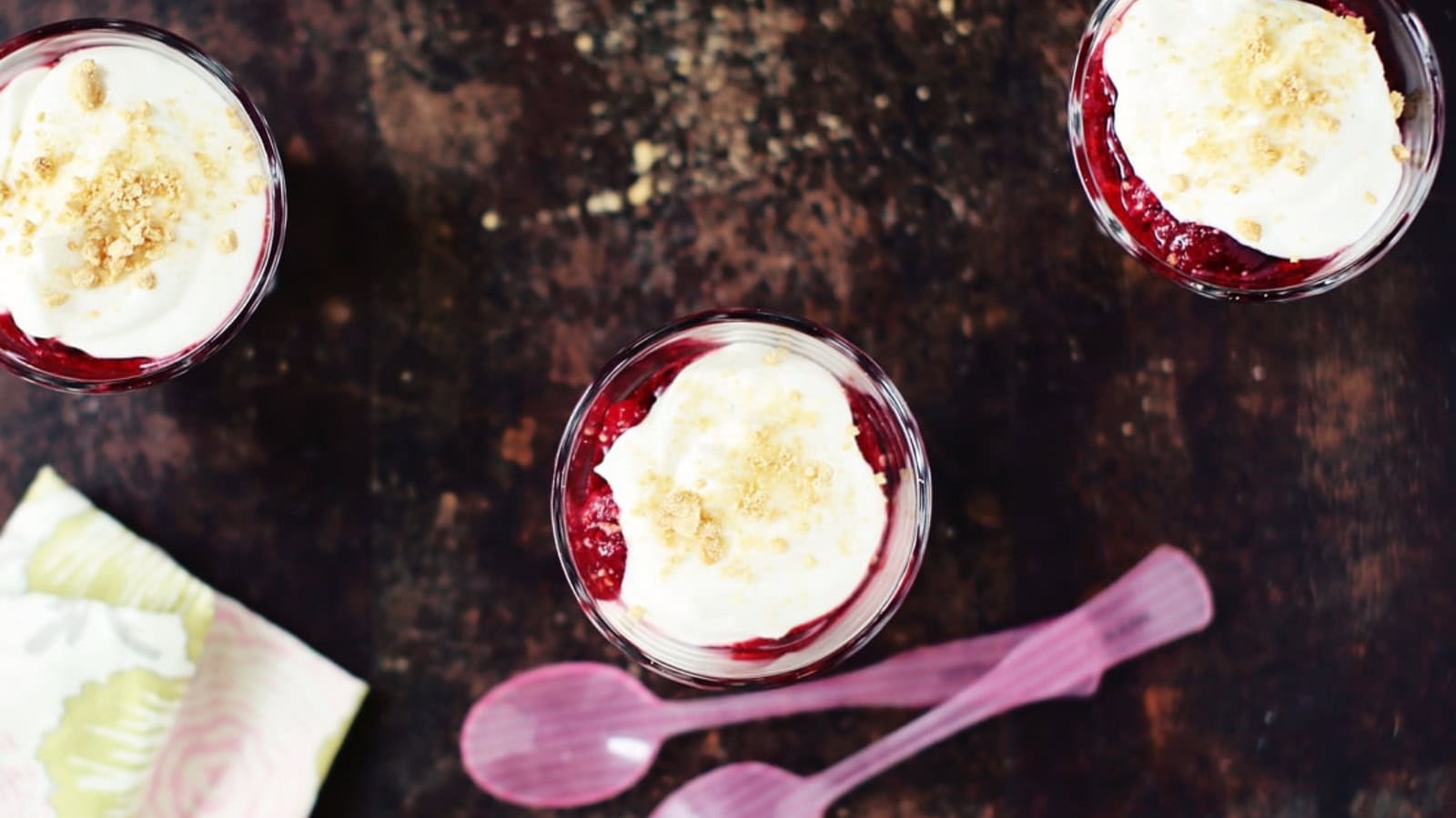 Mini cheesecakes topped with raspberry sauce and creamy filling.