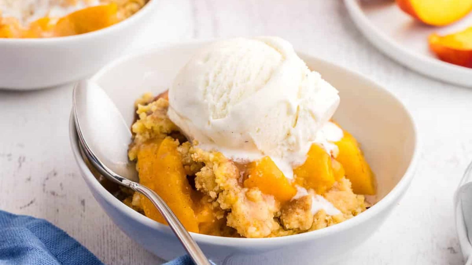 Peach cobbler baked with juicy peaches and golden cake topping.