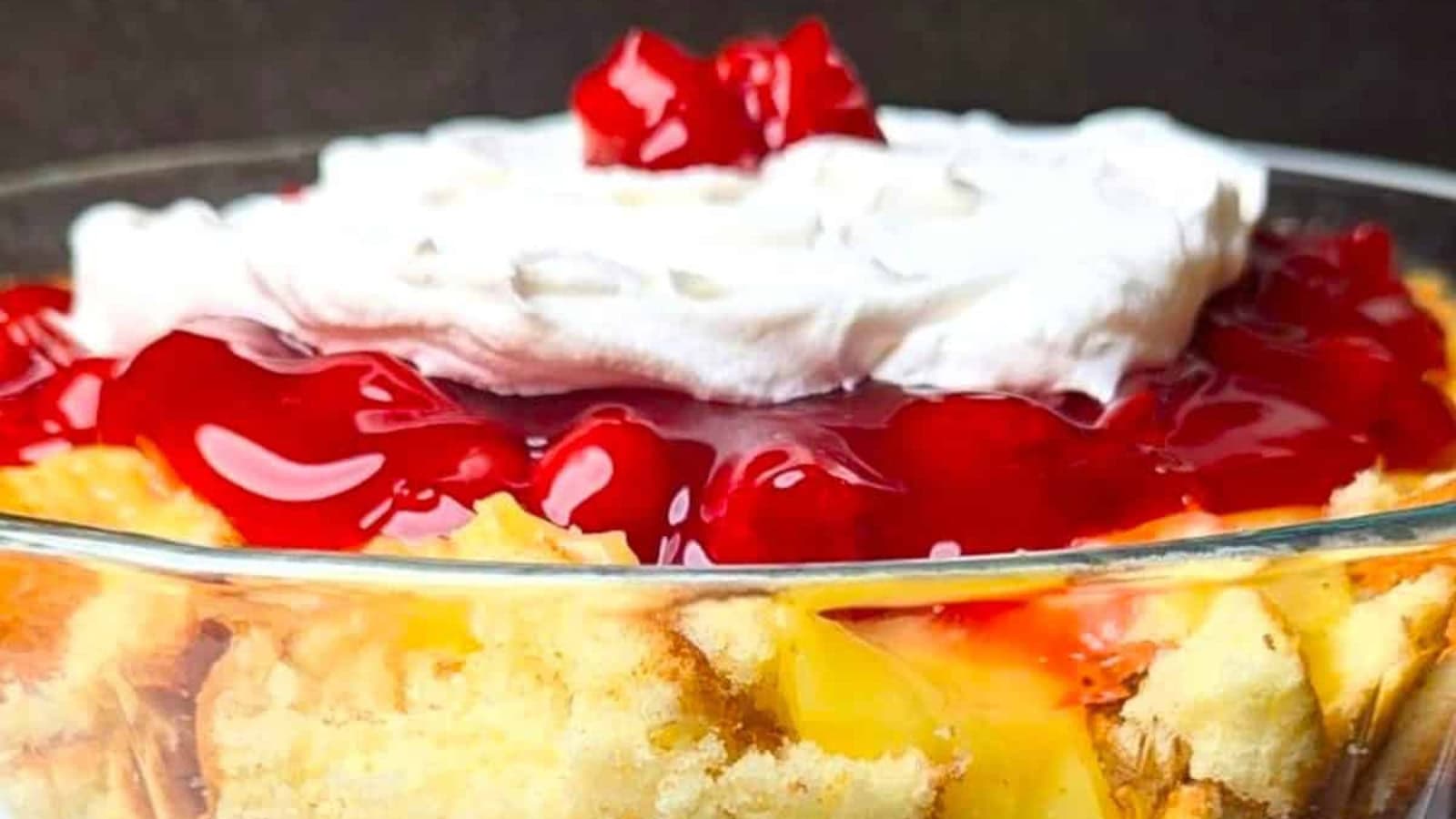 Layered punch bowl cake filled with cake, fruit, and whipped topping.