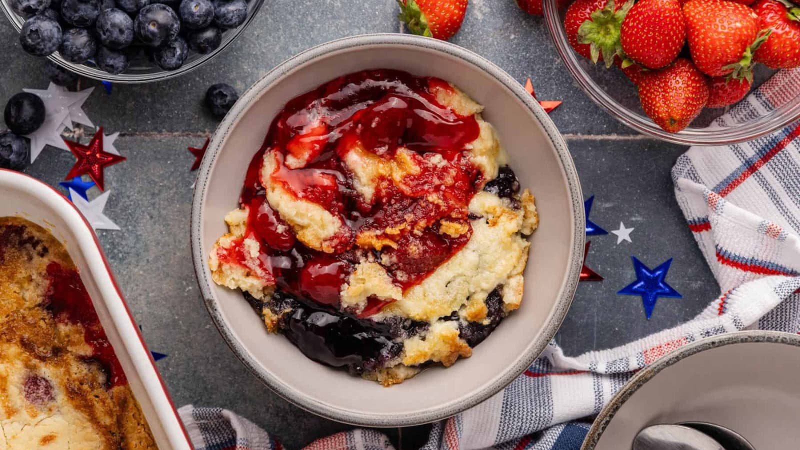 Dump cake baked with berries and golden topping in patriotic colors.