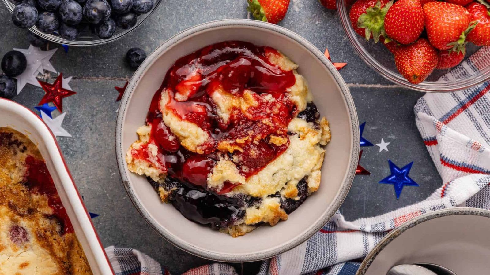 Dump cake baked with berries and golden topping in patriotic colors.