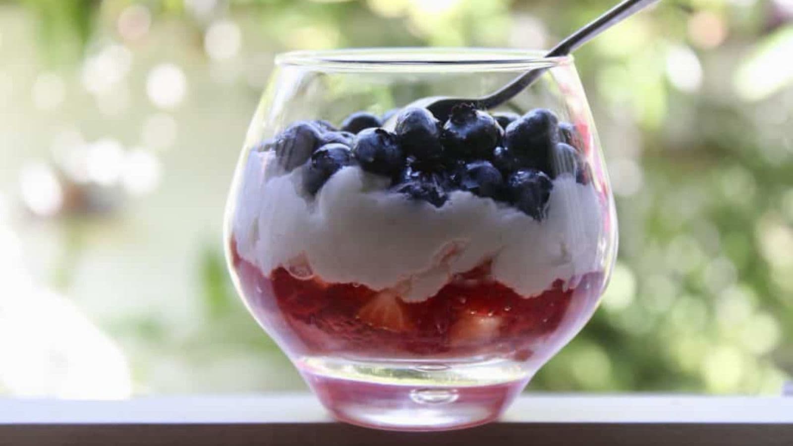 Mini trifles layered with berries, cream, and cake in patriotic colors.