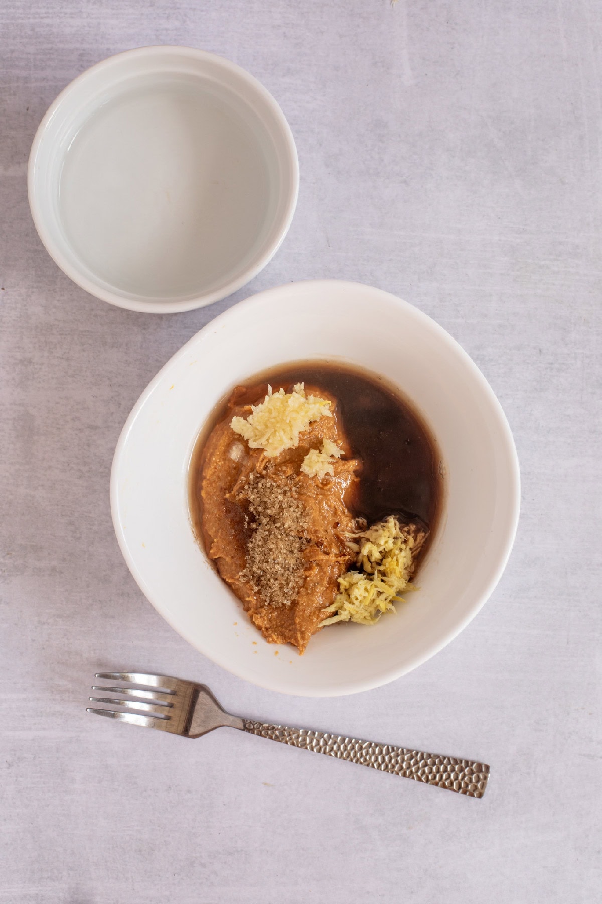 Peanut sauce ingredients are combined in a bowl for spring roll dressing.