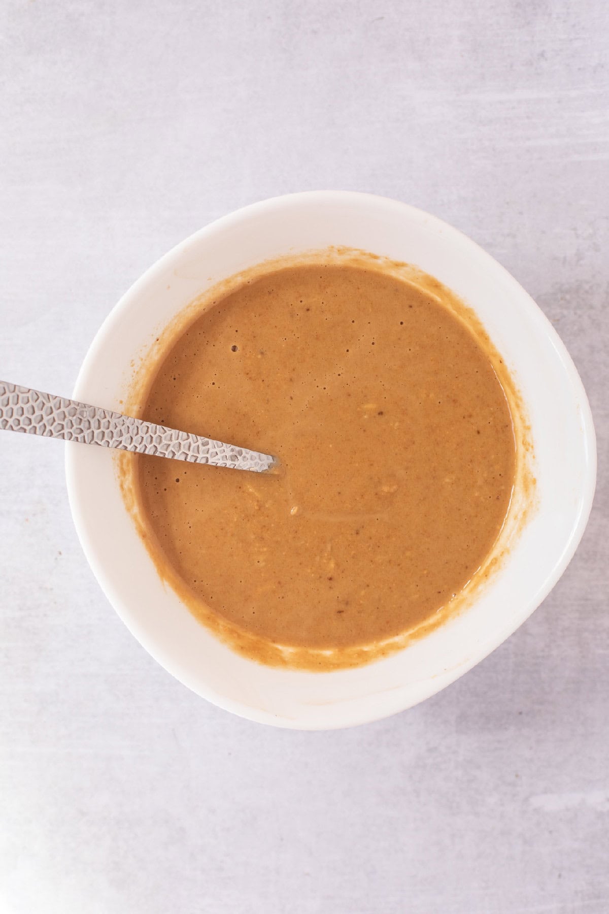 Creamy homemade peanut sauce mixed for spring roll in a bowl recipe.
