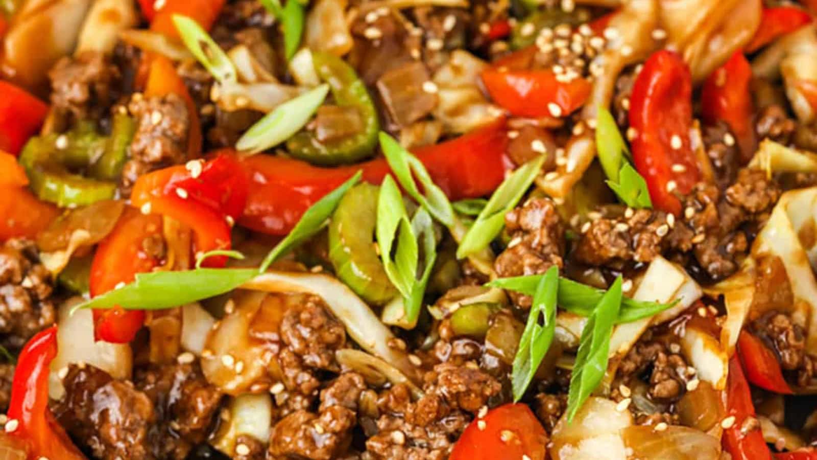 Ground beef stir fry served with colorful vegetables and rice.