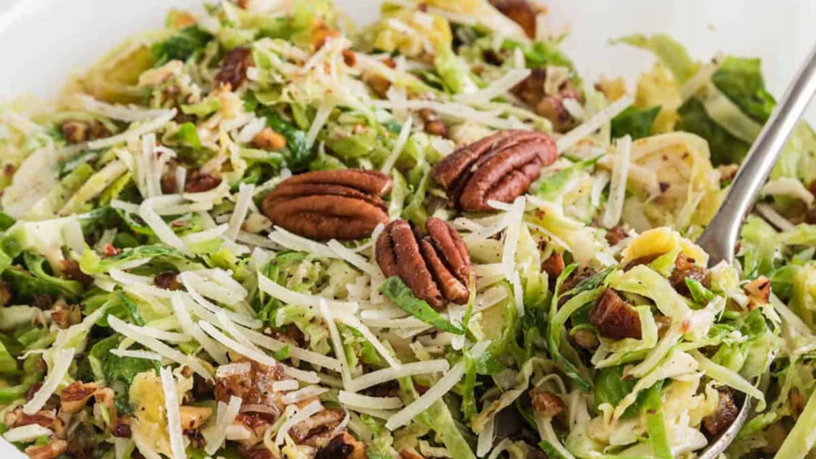 Shaved Brussels sprouts salad tossed with light dressing and toppings.