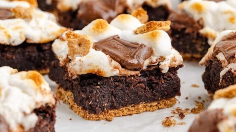 Brownies topped with marshmallows and graham cracker pieces.