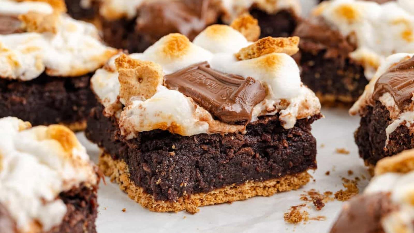 Brownies topped with marshmallows and graham cracker pieces.