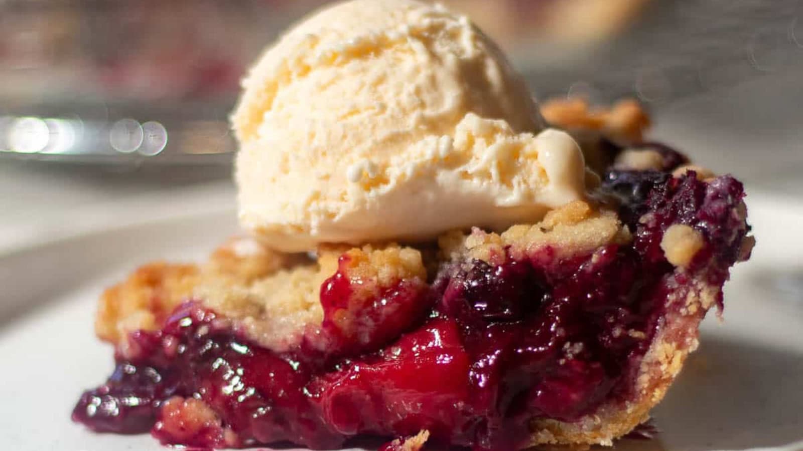 Berry pie filled with strawberries and blueberries in a flaky crust.