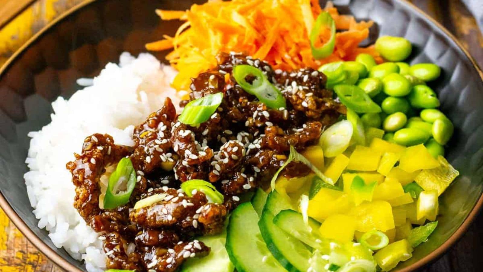 Teriyaki beef bowls served with rice and glossy savory sauce.