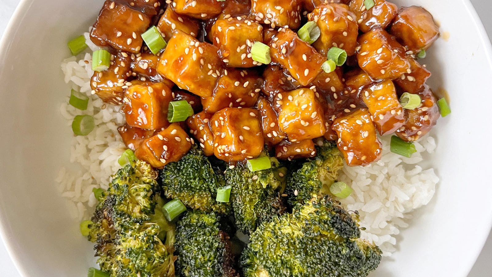 Teriyaki tofu glazed with savory sauce and served with rice.