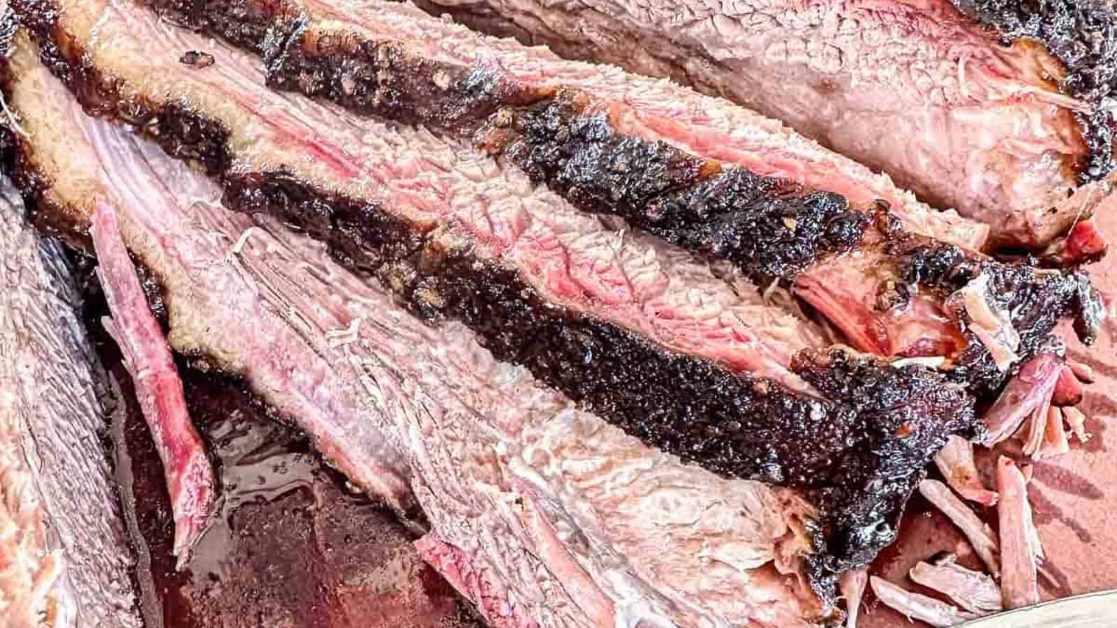 Smoked brisket sliced tender with a dark, flavorful crust.