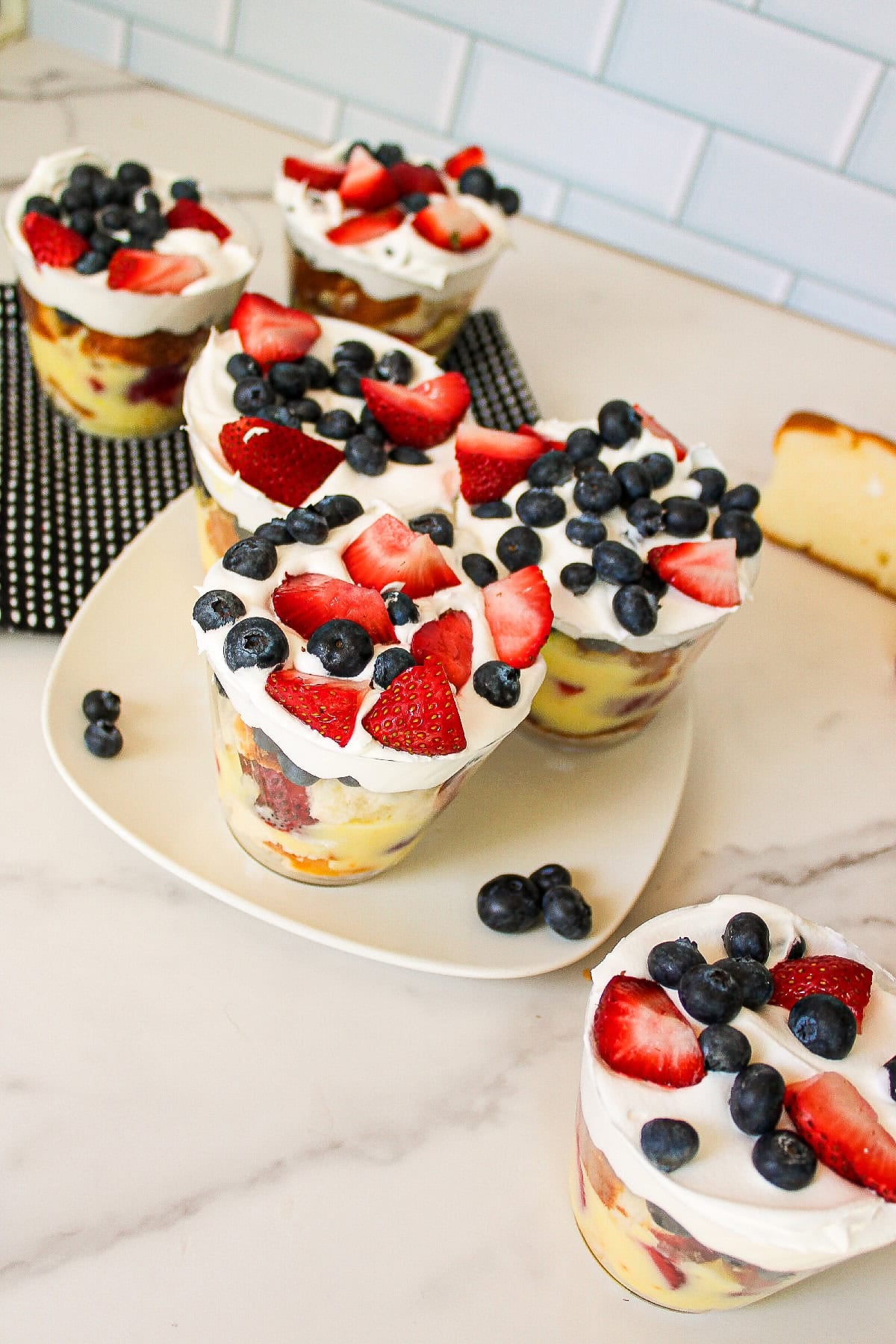 Easy berry parfait cups served with strawberries, blueberries, whipped cream, and vanilla pudding layers.